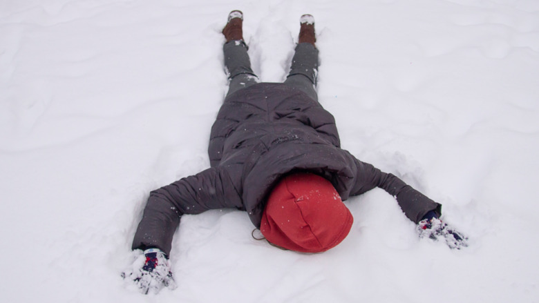 A man lying face down in the snow