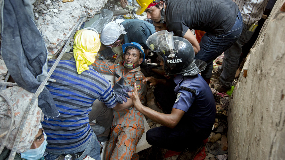 Rescuers pulling someone from rubble