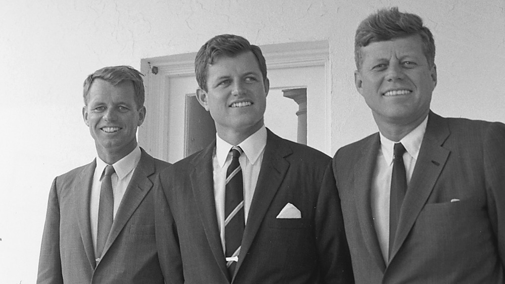 President Kennedy smiling with his brothers