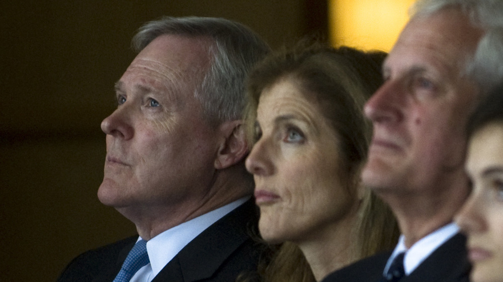 Ray Mabus sits next to Caroline Kennedy, both looking up