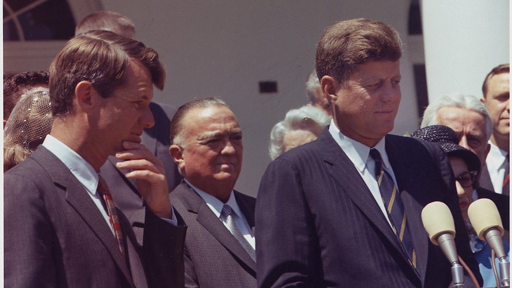 Robert F. Kennedy, J. Edgar Hoover, President Kennedy. standing 