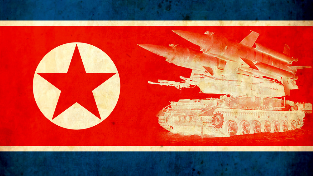 North Korean flag with military artillery on it 