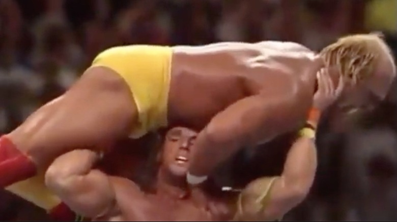 The Ultimate Warrior holding Hulk Hogan over his head