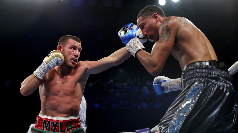 Boxers punching in ring