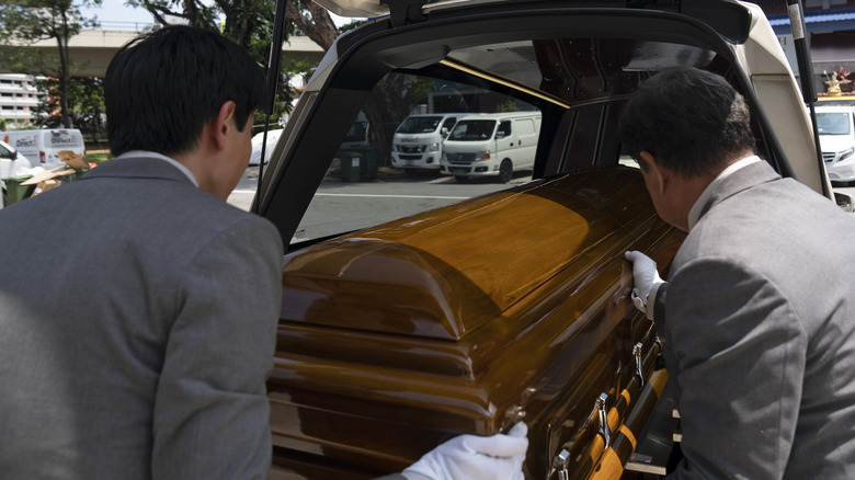 Singapore casket being put into a hearse 