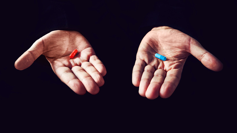 red pill or blue pill in open hands