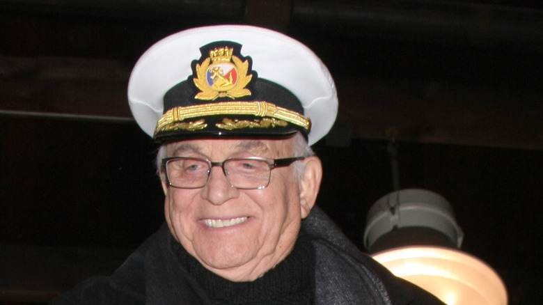 Gavin MacLeod wearing captain's hat