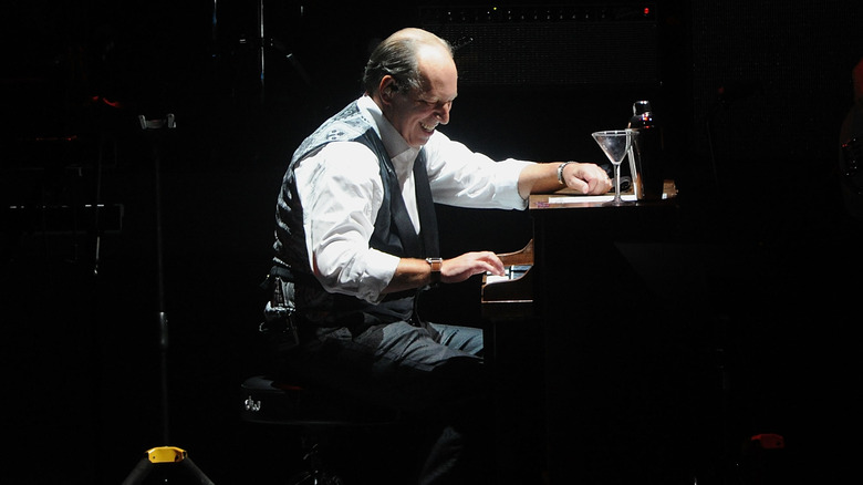 Hans Zimmer playing piano with martini glass
