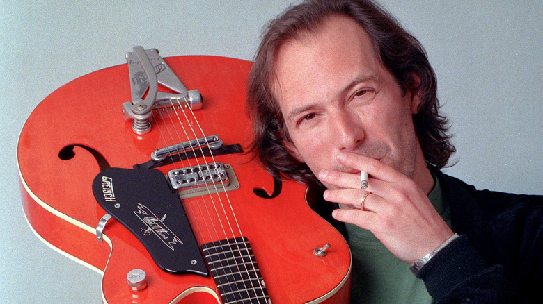 Hans Zimmer with guitar, smoking cigarette