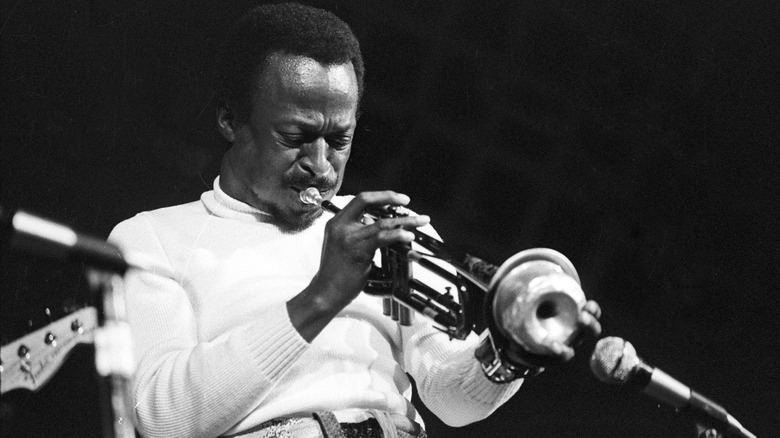 Miles Davis performing with trumpet