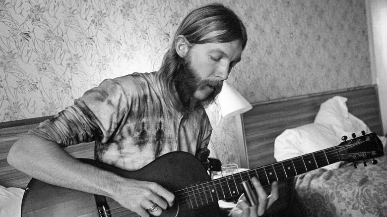 Duane Allman playing guitar in hotel room
