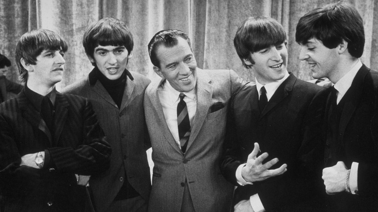 Ed Sullivan with the Beatles, all smiling 