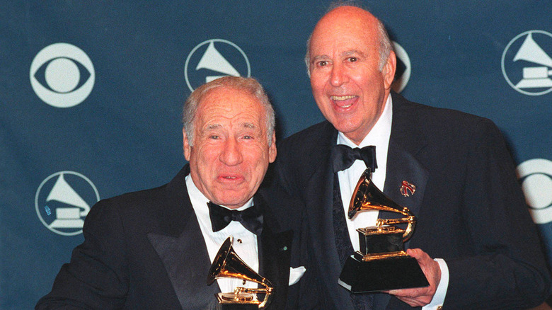 Mel Brooks and Carl Reiner smiling and holding Grammys
