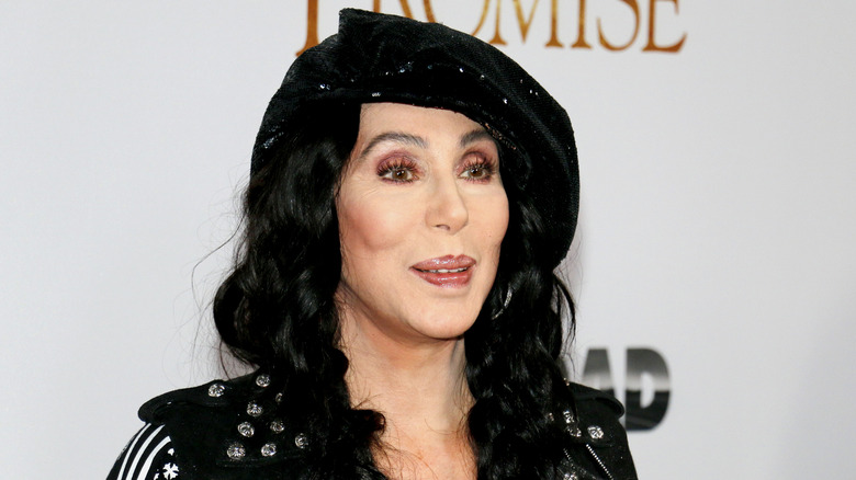Cher in a black hat