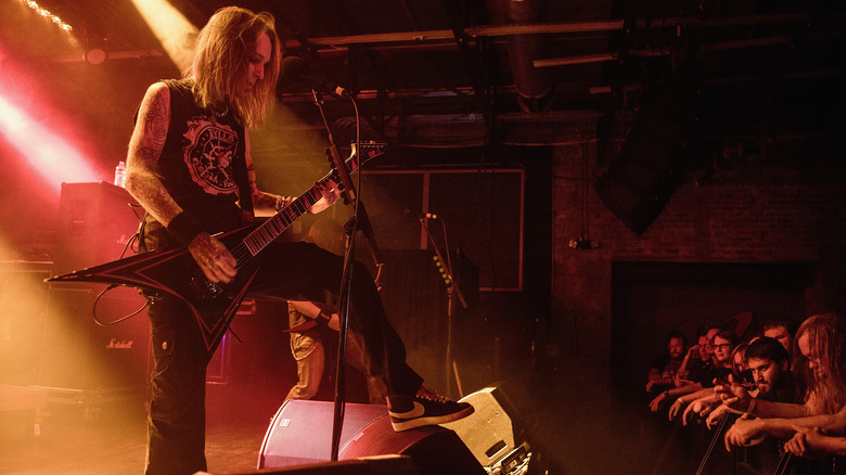 Alexi Laiho playing guitar edge of stage