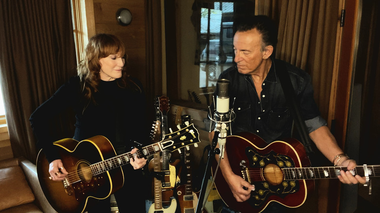 Springsteen and Scialfa playing guitar