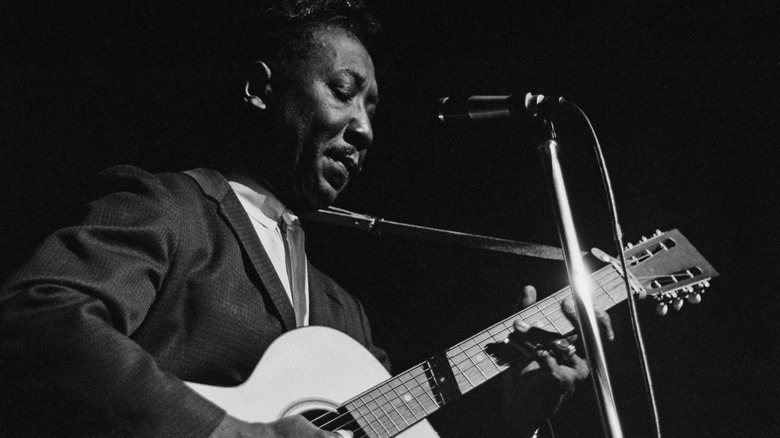 Muddy Waters performs with an acoustic guitar