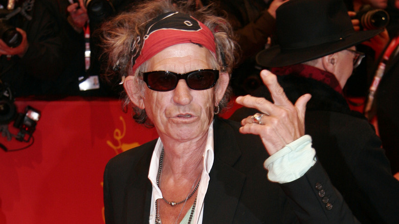 Keith Richards gesturing in sunglasses
