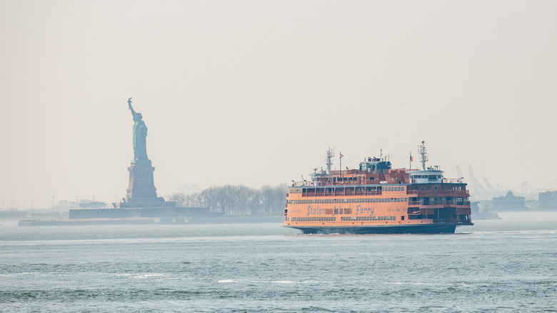 Statue of Liberty with Staten Island Ferry in foreground