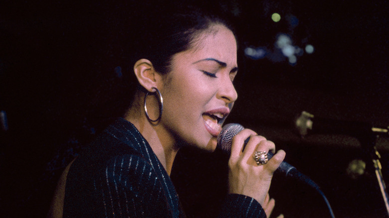 Selena singing into the microphone