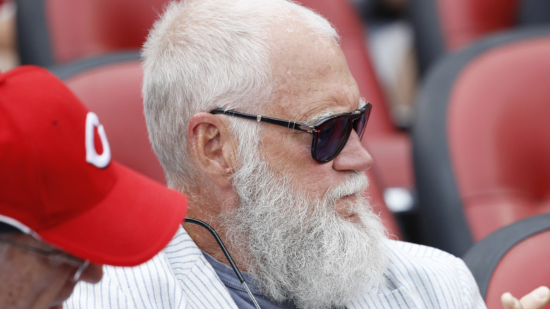 David Letterman sitting at a basketball game