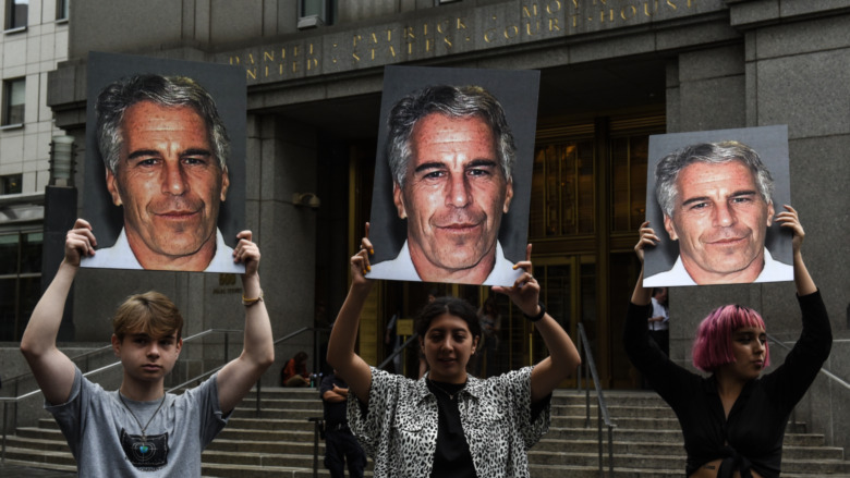 Protesters with posters of Jeffrey Epstein 