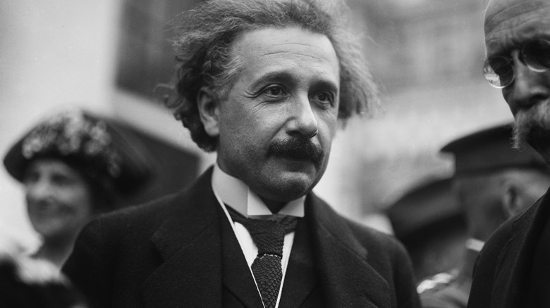 Albert Einstein standing in crowd