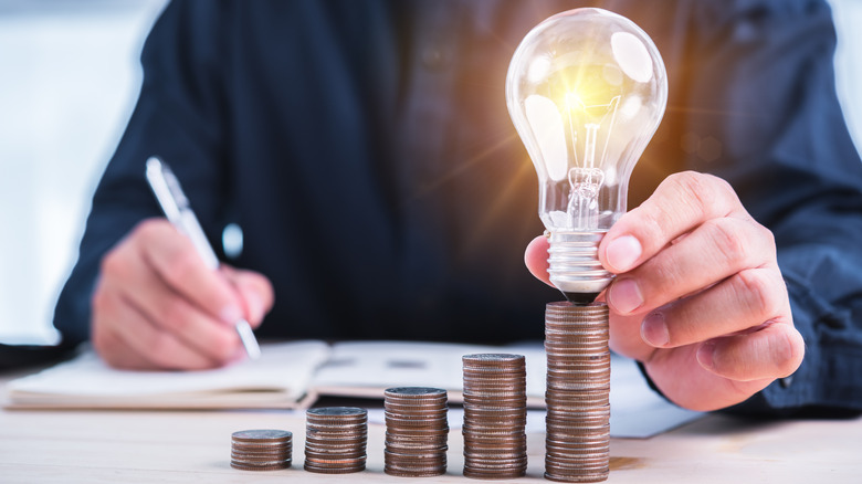 Lightbulb on stack of coins