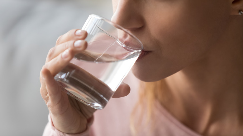 Thirsty woman drinking water