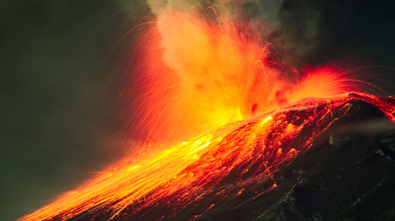 an exploding volcano expelling molten material