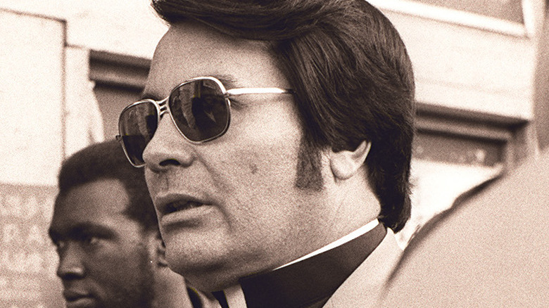 Cropped photo by Nancy Wong of Jim Jones at a protest in San Francisco in 1977, https://creativecommons.org/licenses/by-sa/3.0/