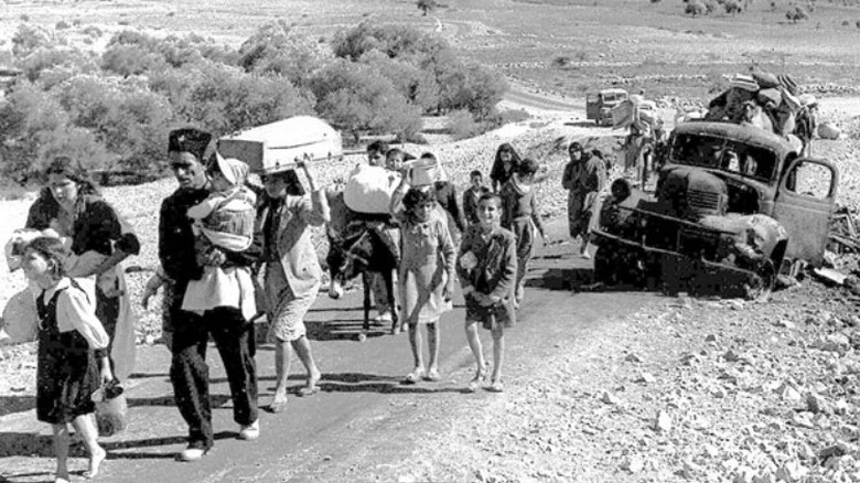 Palestinian Refugees walking in desert