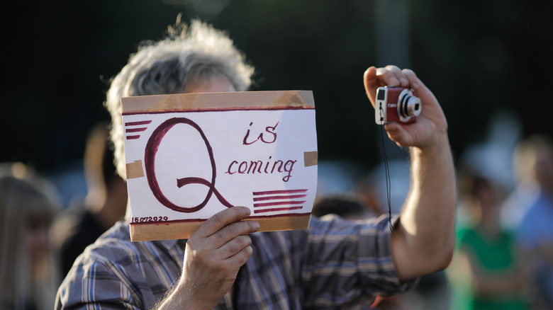 A QAnon follower with sign