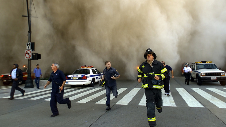 First responders run from a dust cloud 