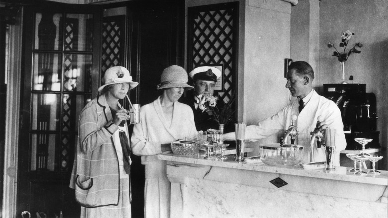 Barman serves at soda fountain 