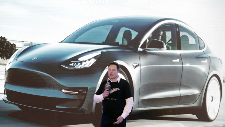 Musk and Tesla Model 3