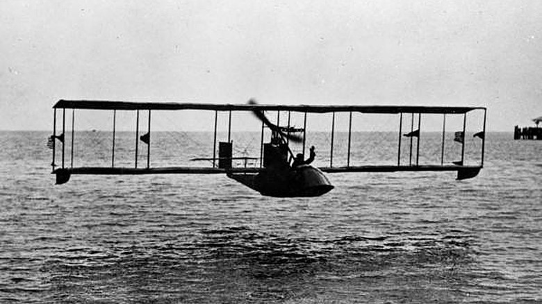 Biplane over the water