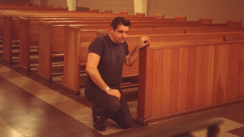 Albert DeSalva kneeling in prison church