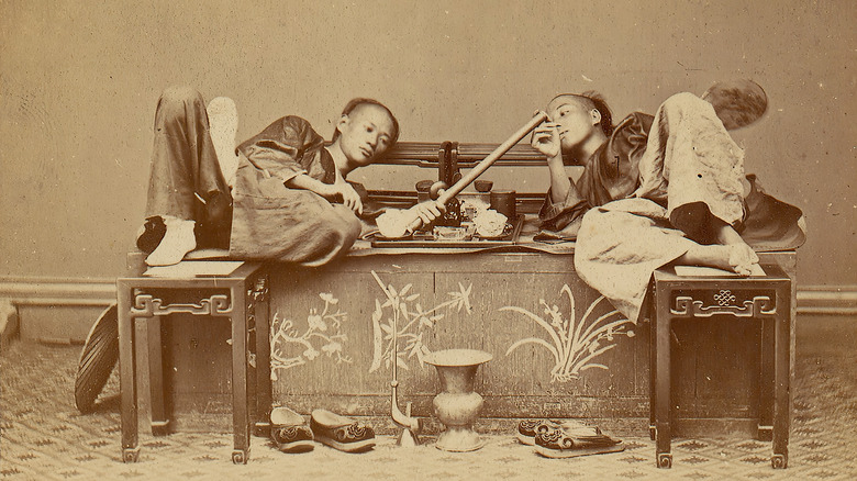Opium Den with two people smoking pipe