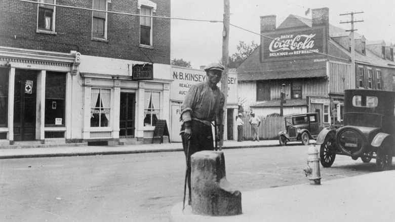 A former slave stands in front of a Virginia bank in the 1930s