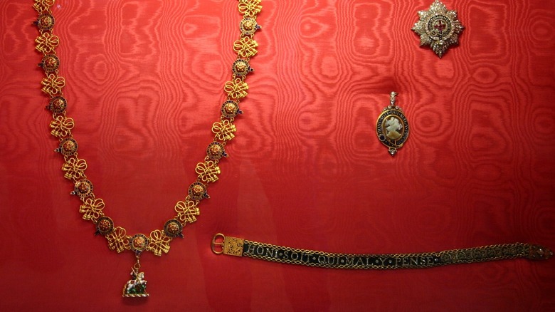 order of the garter badges and regalia on red background