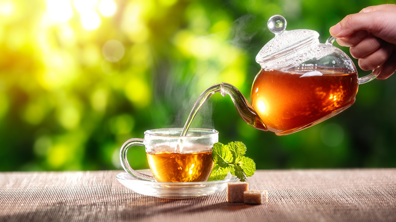 tea is poured into a cup