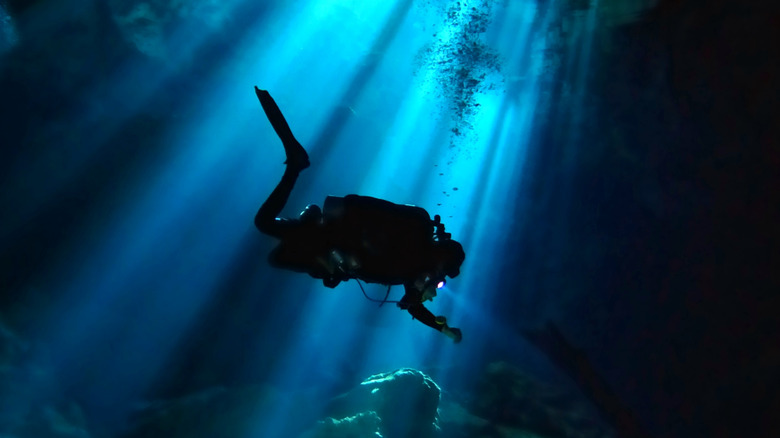 Underwater diver in a beam of light