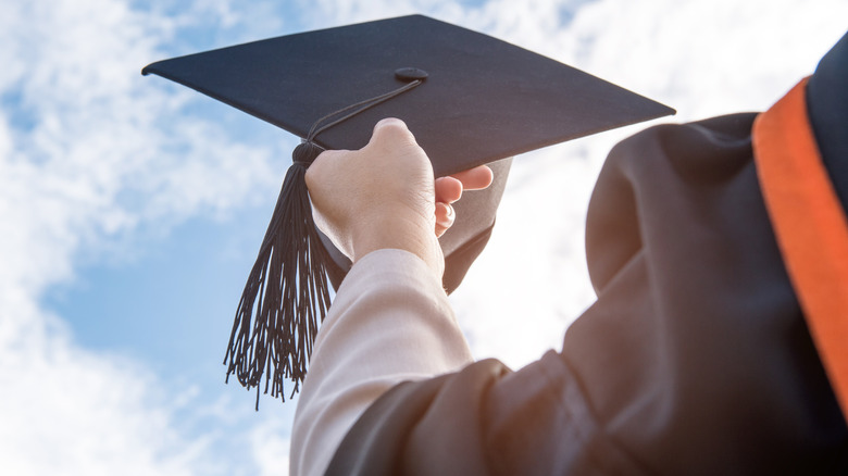 Student holding graduation cap