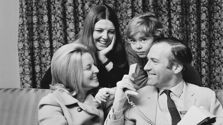 John Stonehouse with family smiling