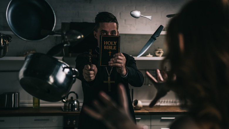 Priest being attacked by possessed woman