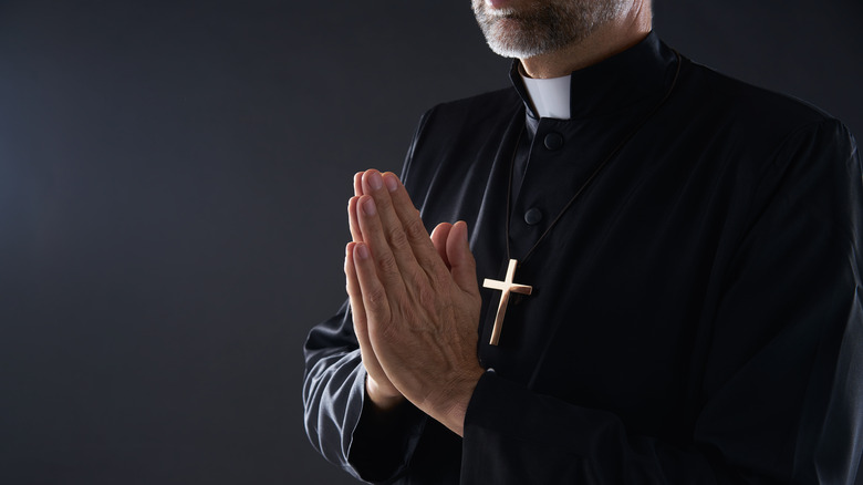 Priest with hands together to pray