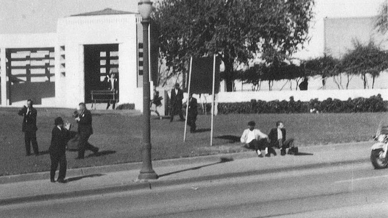 Witt next to other man on sidewalk