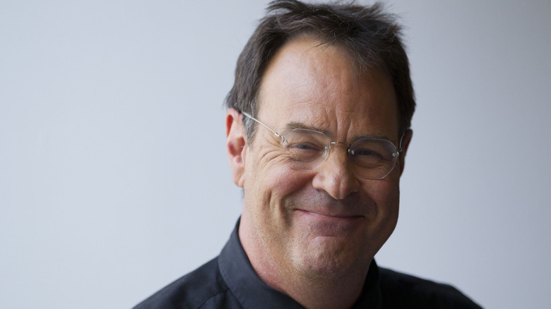 A smiling closeup shot of Dan Ackroyd