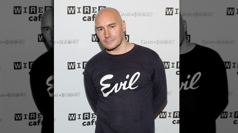 Grant Morrison with a shirt reading 